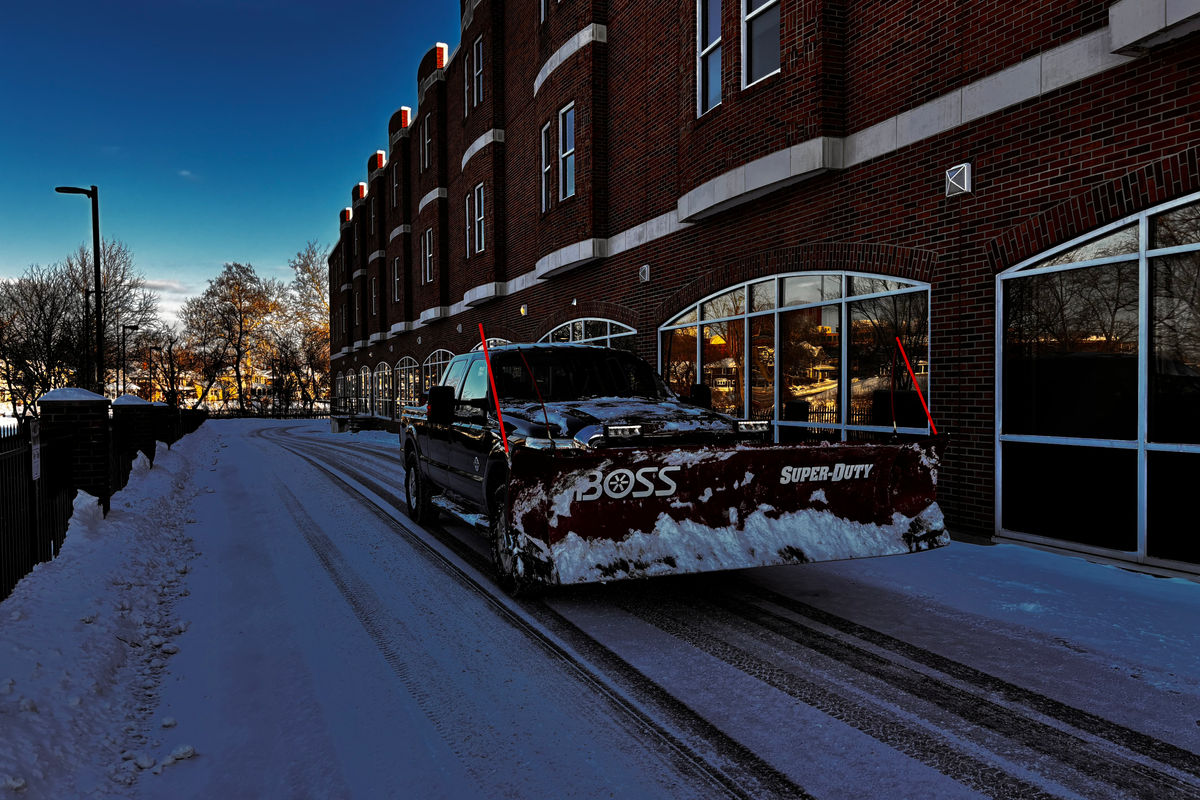 Snow removal equipment clearing a residential driveway